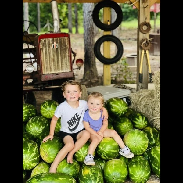 farmers-market-kids-on-watermelons
